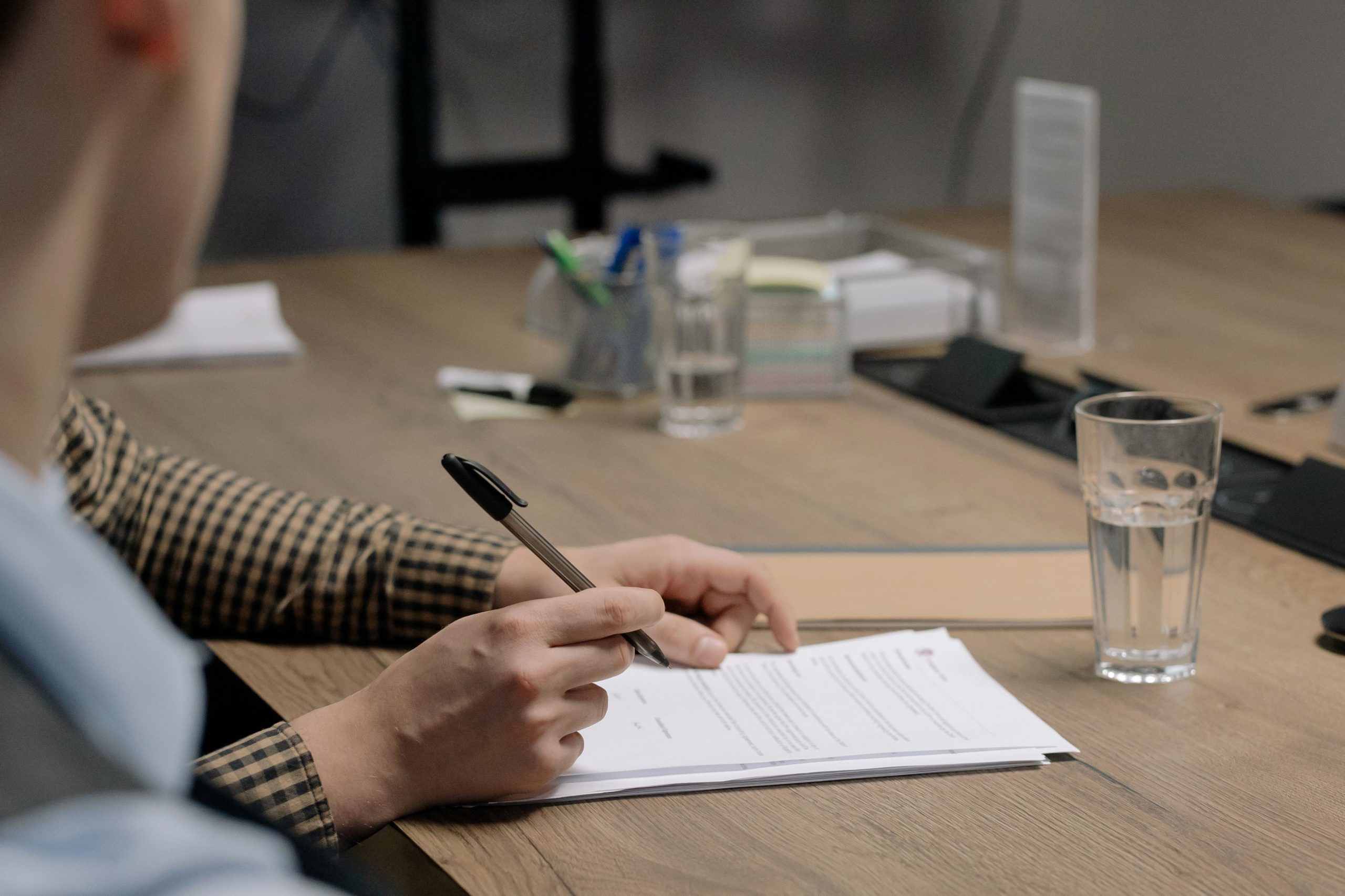 Personne en costume signant un document professionnel