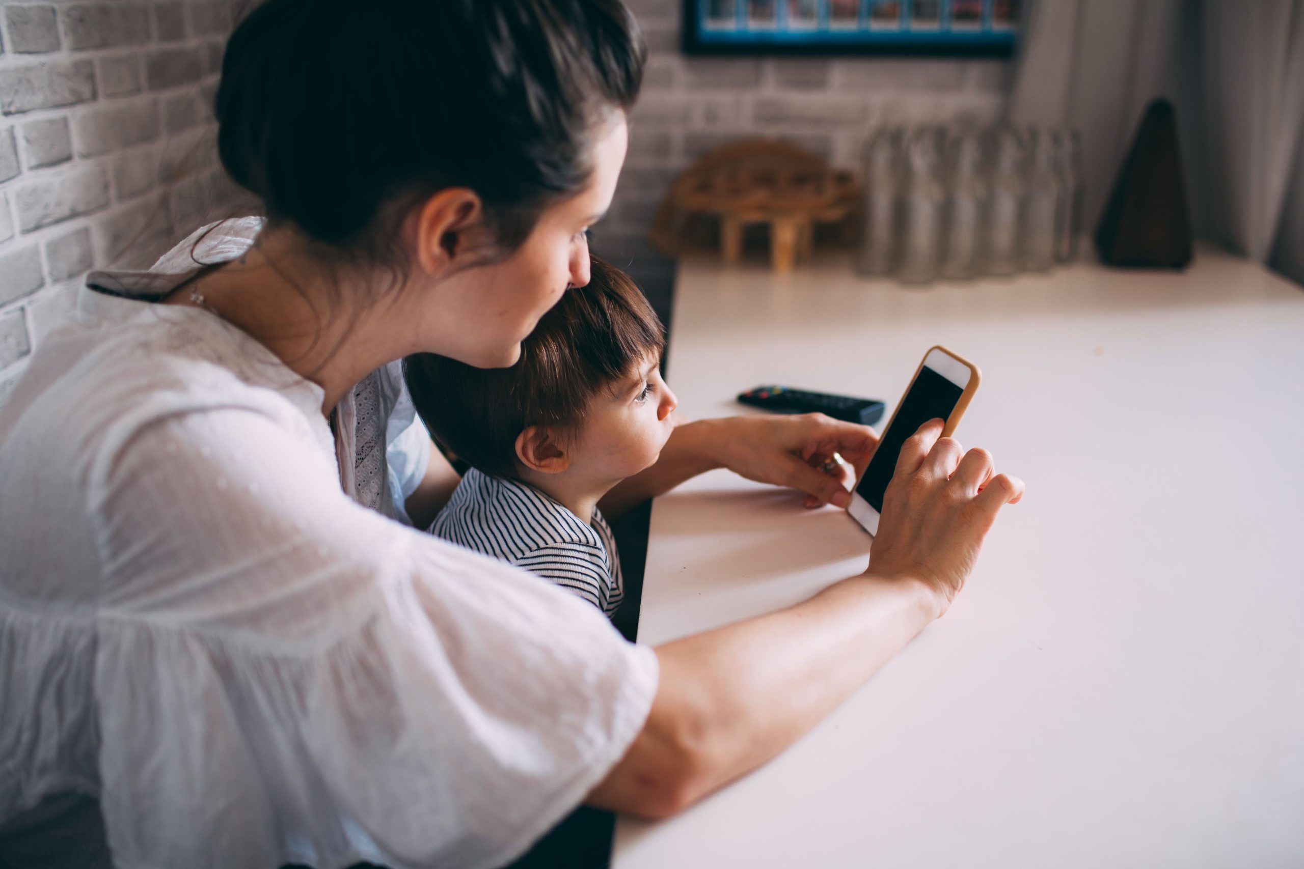 Femme et enfant interagissant avec téléphone